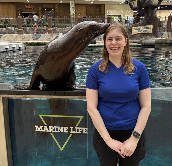 A seal at West Edmonton Mall's Marine Life enclosure gives Megan a kiss on the cheek.