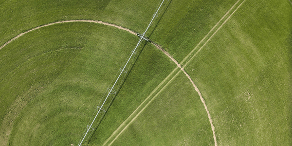 An aerial view of a circular irrigation system in a green field