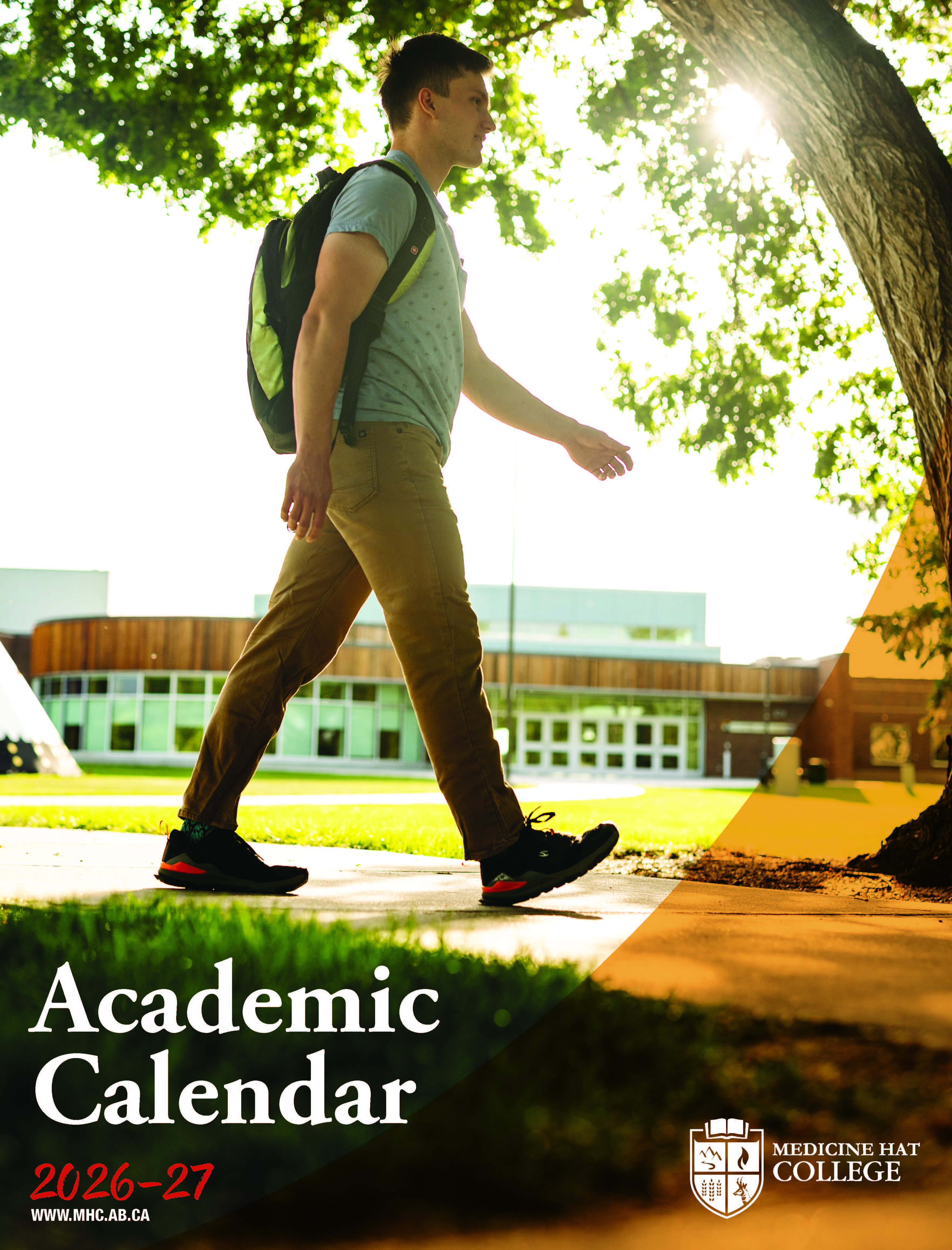 2025-2026 Academic Calendar cover. Male student sitting at table with books. 