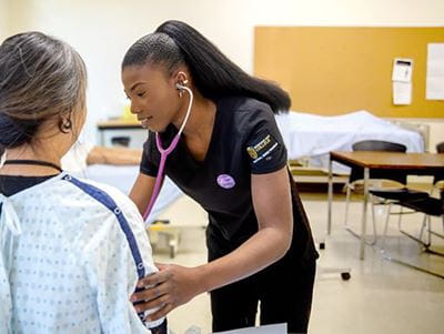Brooks Campus Practical Nursing student test a patient during a lab session