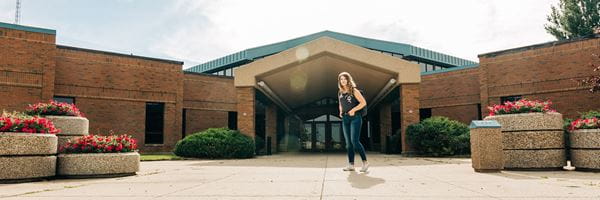 Student walking into Brooks Campus Main Entrance