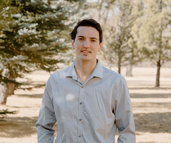 Zenon Parchewsky standing outside with trees in the background