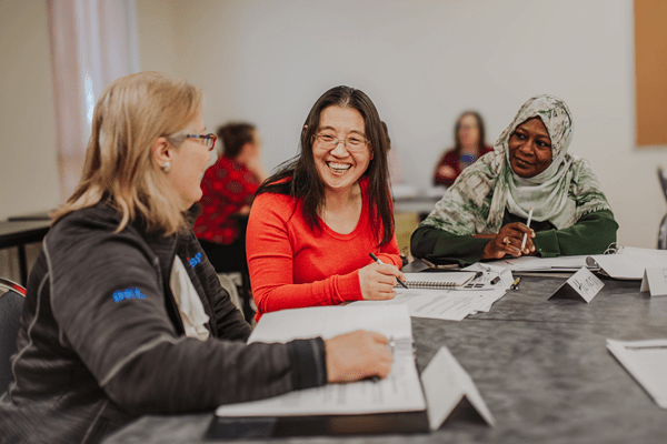 A group of 3 mature students learning in a classroom