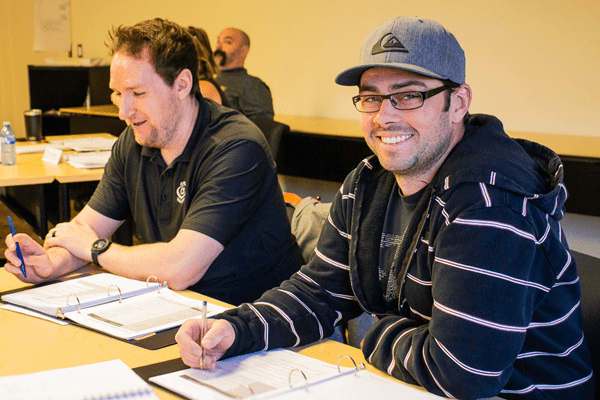 Two mature students learning in a classroom