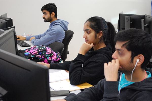 Three students working on computers