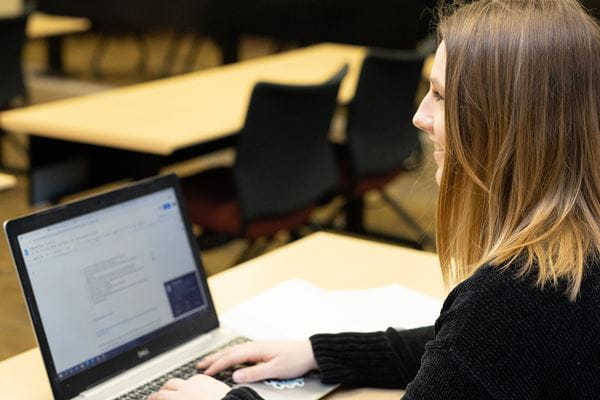 Student studying with laptop.