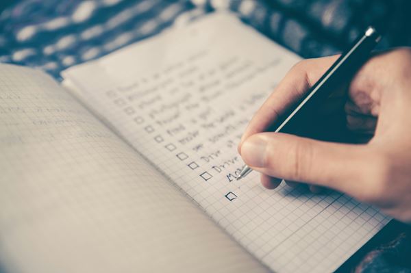 Man writing on checklist