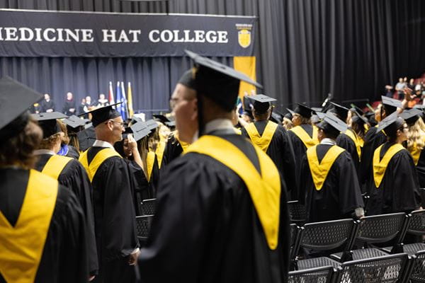 Graduates of Medicine Hat College wait to be called to the stage at convocation.