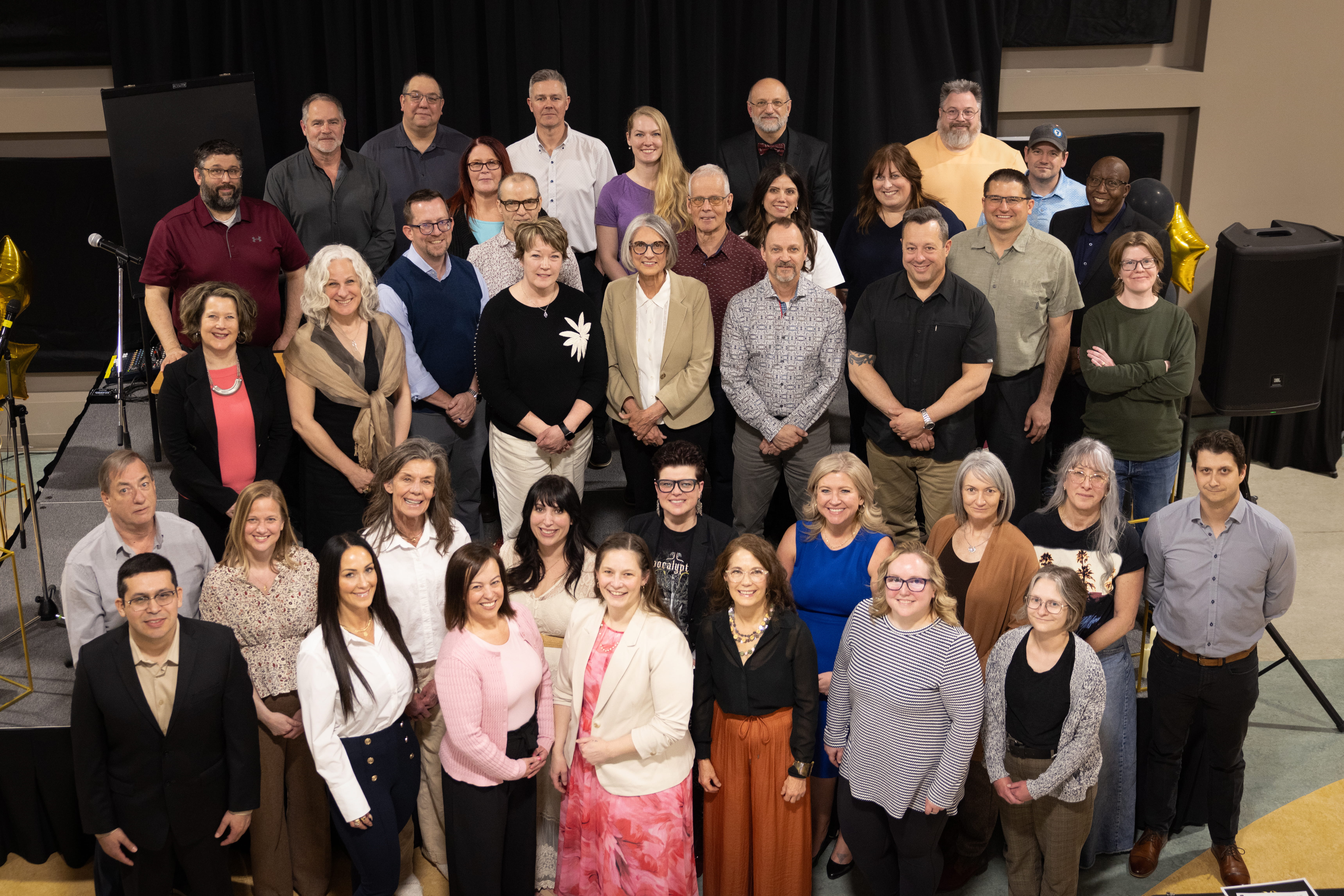 MHC employees celebrate long service awards at 2024 recognition event.
