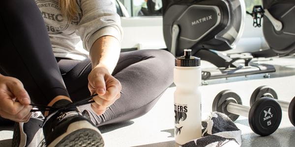 Close of student tying shoes in the Fitness Centre