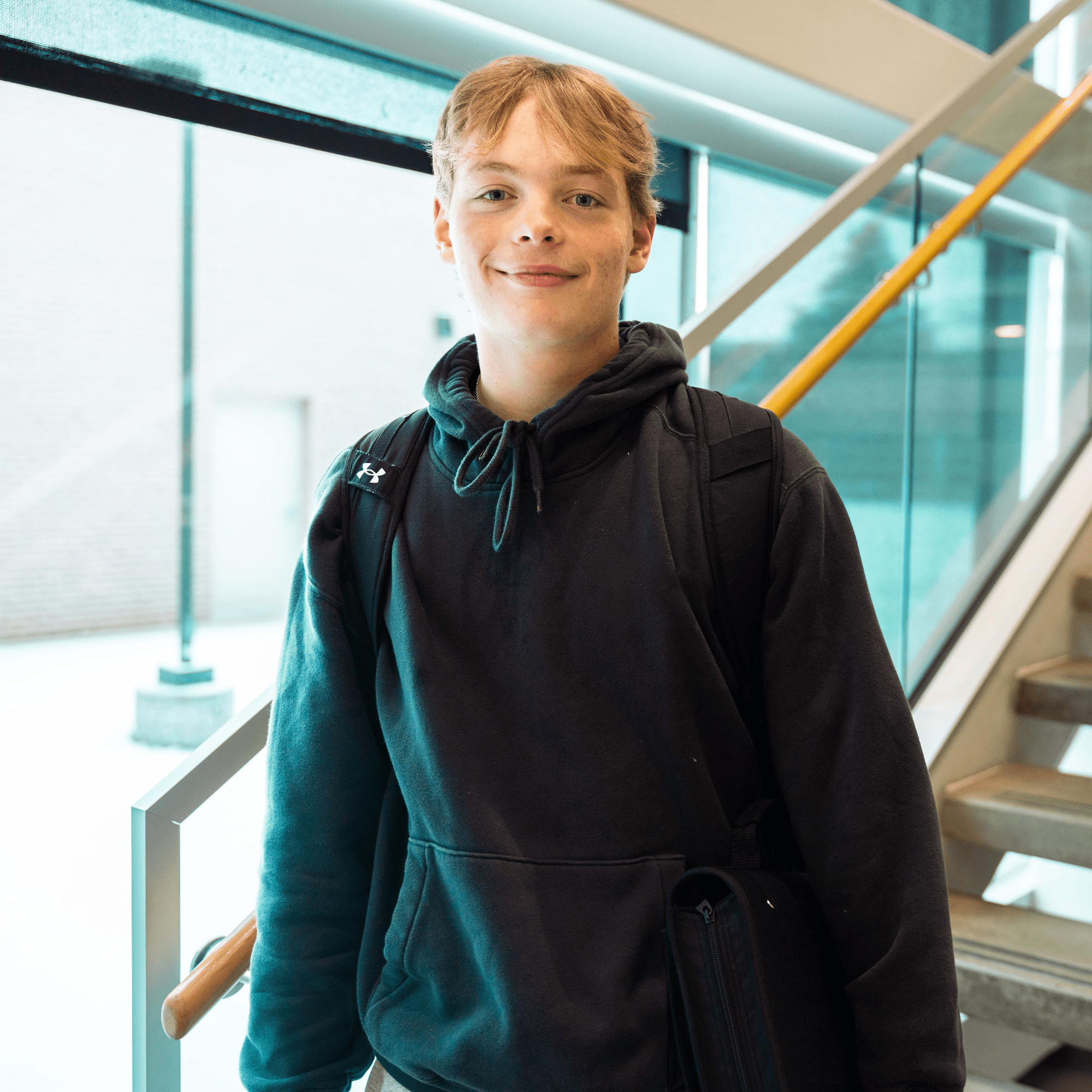 Male student smiling at camera at bottom of staircase. MHC Open House 2026 | October 27 from 11:00 a.m. to 7:00 p.m.