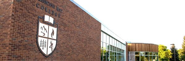 Exterior view of Co-op Wellness Commons with MHC crest