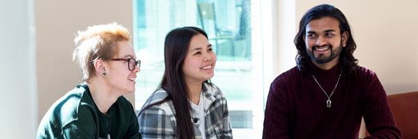 Three students sitting and talking