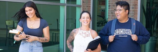 Three students standing outside of MHC