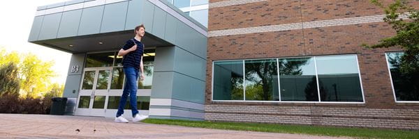 Student walking outside library