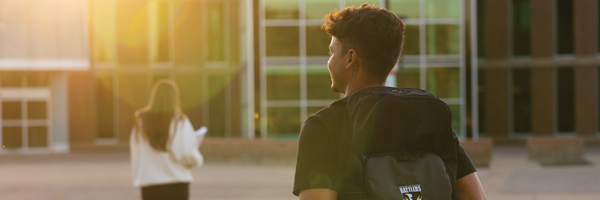 Two students walking towards the front entrance of Medicine Hat College.