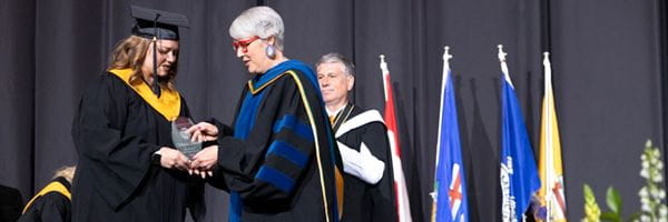 MHC student accepting award at convocation.