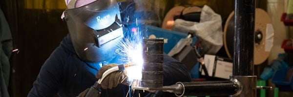 MHC faculty demonstrates welding technique. 