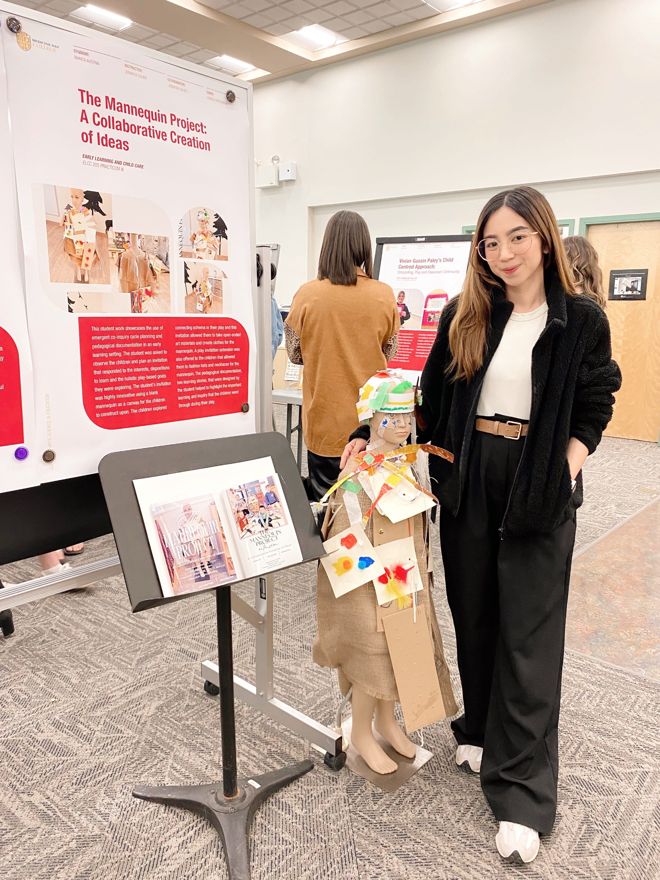 Early Learning & Child Care student, Bianca Austria, poses with her project, The Mannequin Project, at the annual Ignite poster presentation