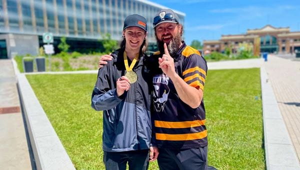 Steamfitter/Pipefitter apprentice, Euan Mackinnon, and MHC instructor, Chad Baron, pose outside of ExpoCité, in Québec, after Mackinnon's gold-medal win at Skills Canada.