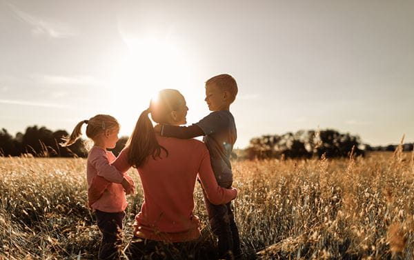 Mother, son and daughter in a golden field 