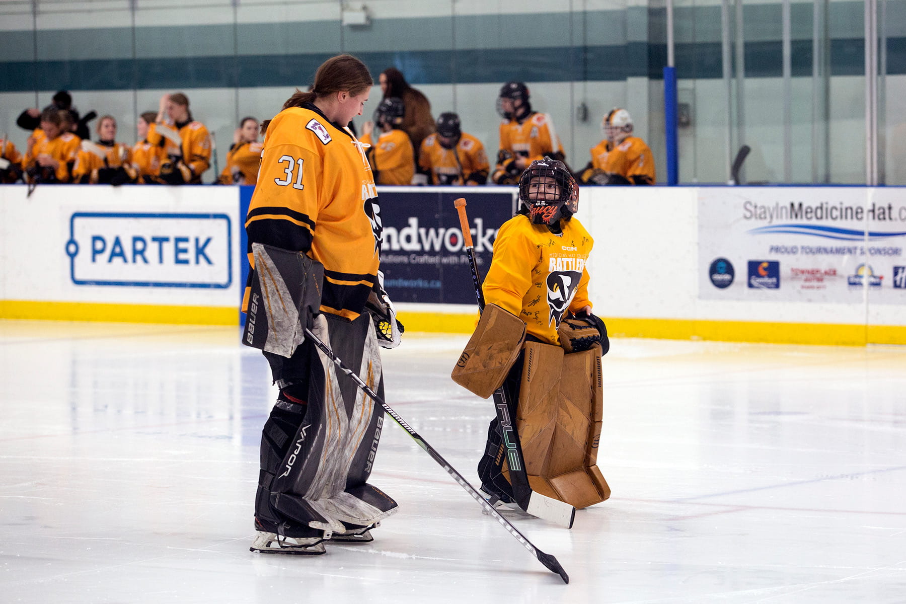 Anna Stewart, former Rattlers women's ice hockey goalie, pictured with a young fan, Sawyer.