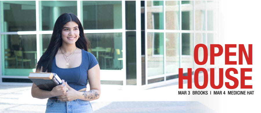 Student holding books outside of MHC, Open House text