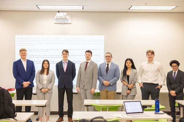 Medicine Hat College Business Administrative students standing in classroom.