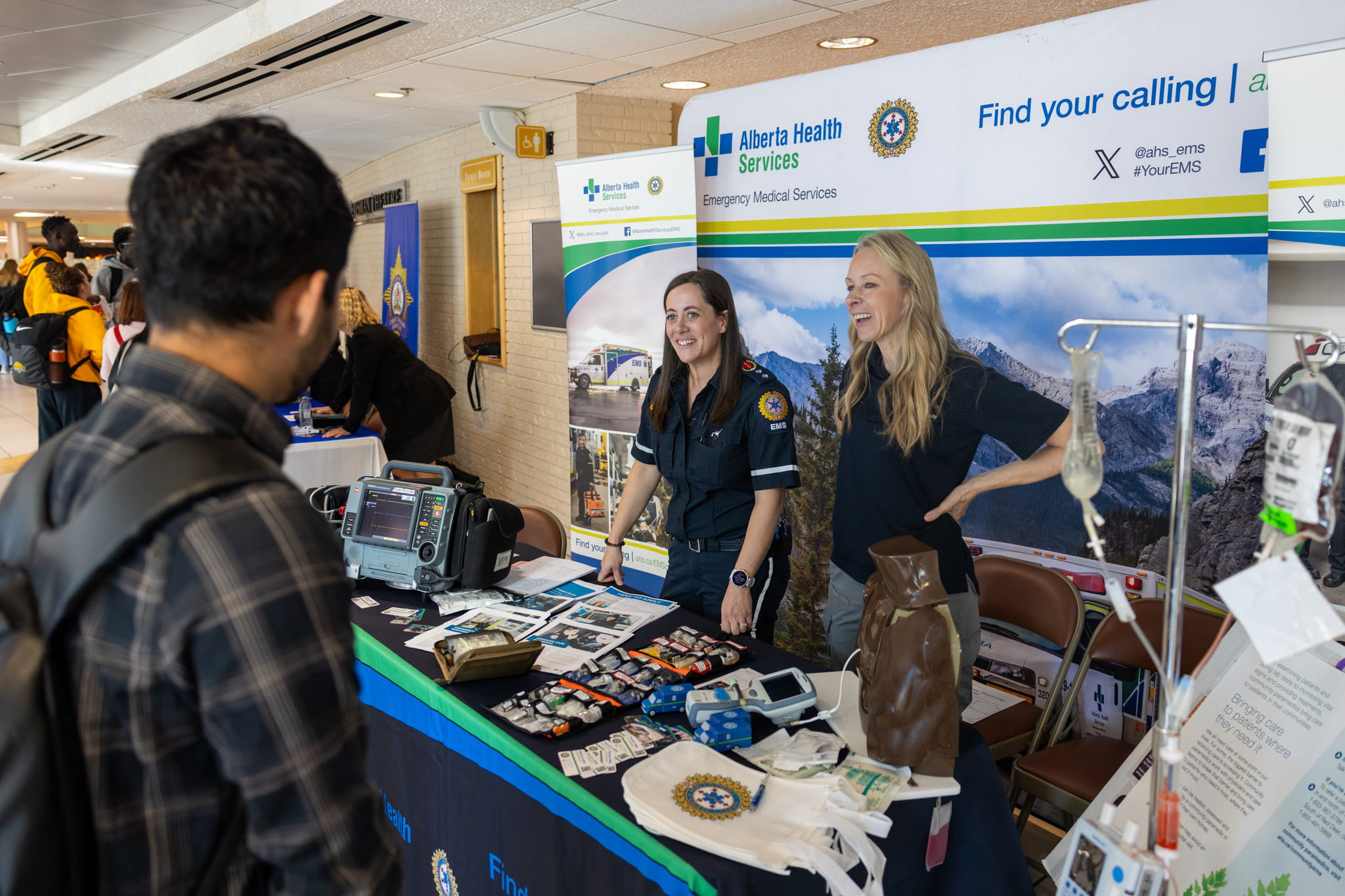 AHS representatives chat with a student at their booth at Career Expo 2025.