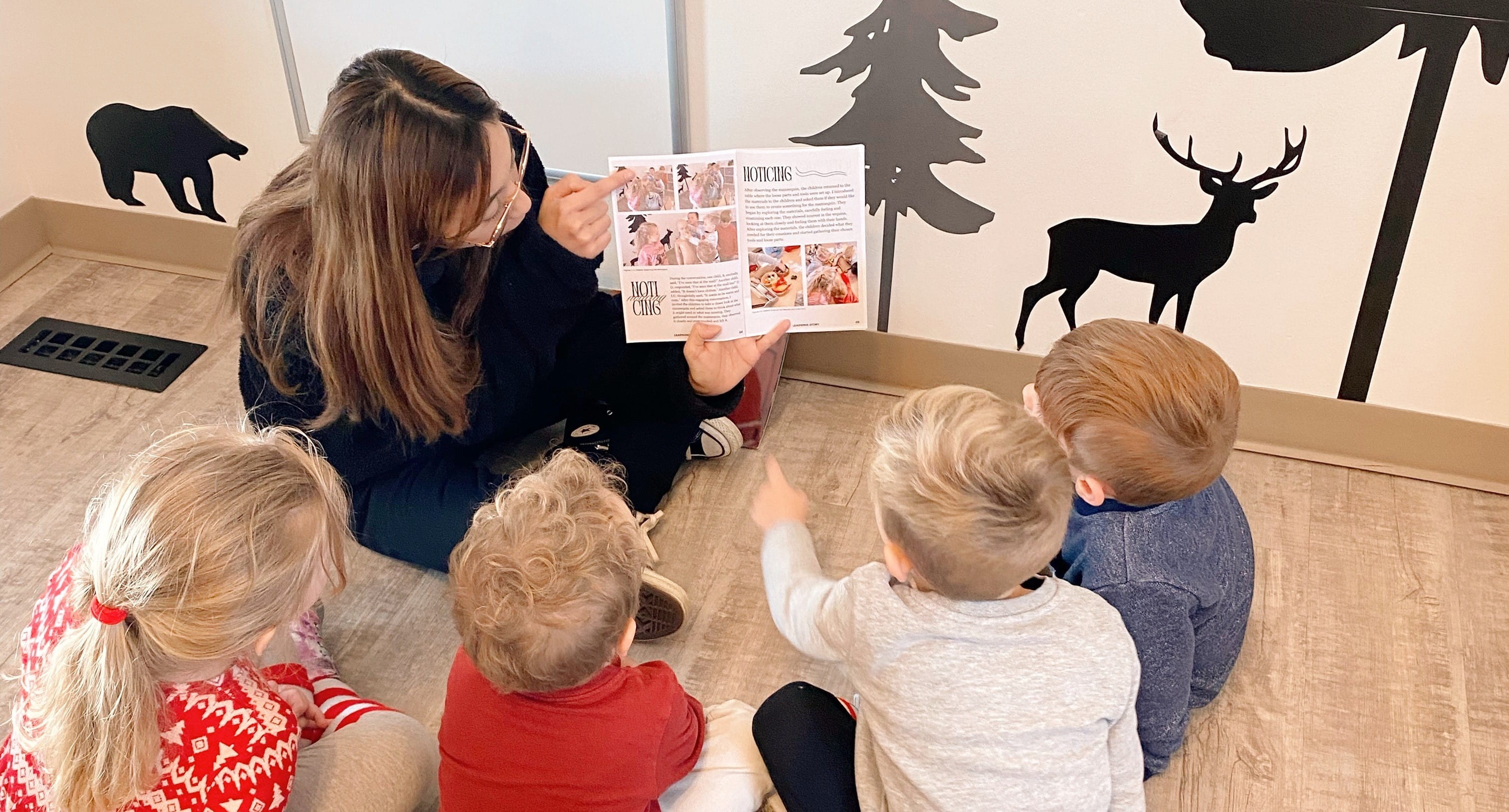 Early Learning & Child Care student, Bianca, reads to four children in her practicum