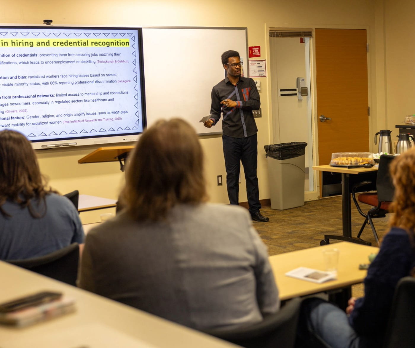 Humanities & Social Sciences student presenting in front of class. 