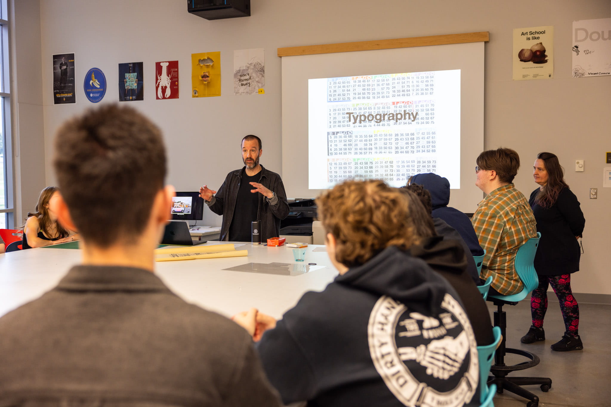 Art & Design instructor, Ian Richmond, presenting to students in a classroom. 