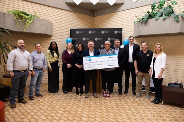Large group standing with large cheque, stating $25, 000 donation from Methanex to Support Trades Education and Indigenous Student Initiatives