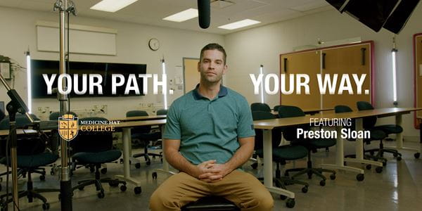 Preston Sloan sitting in lecture classroom - Pathways.