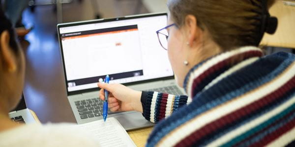 Close up of student working at a laptop