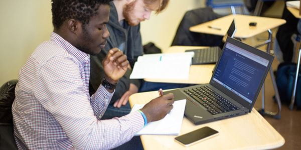 Close up of student working at a laptop.