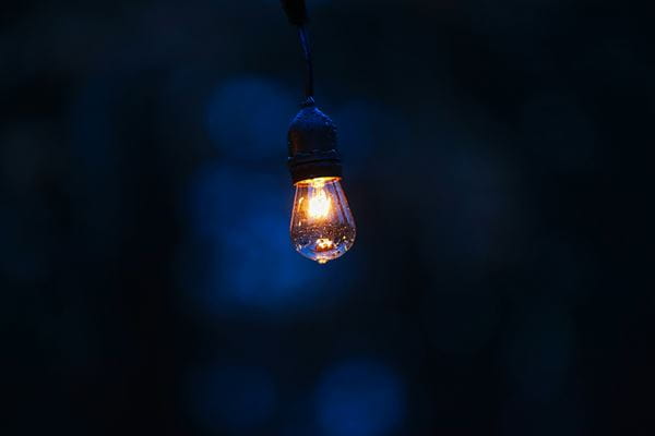 Yellow light lit in a dark blue room. 