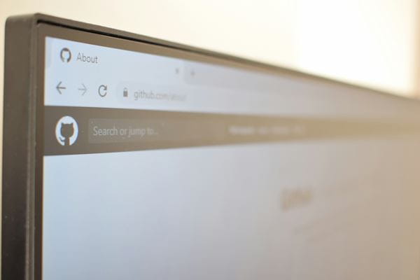 Close up of a computer screen with GitHub icon on a browser tab. 